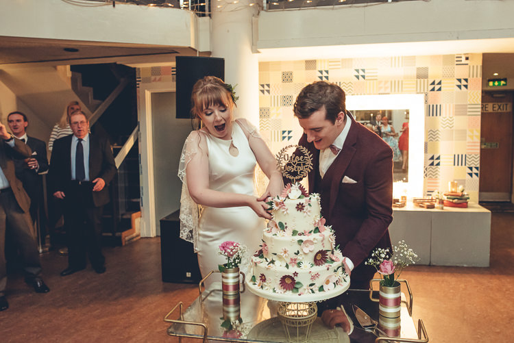Bride Groom Cutting Fun Homemade Cake DIY Three Tier Sugar Flowers | Greenery Burgundy City Autumn Wedding http://lisahowardphotography.co.uk/