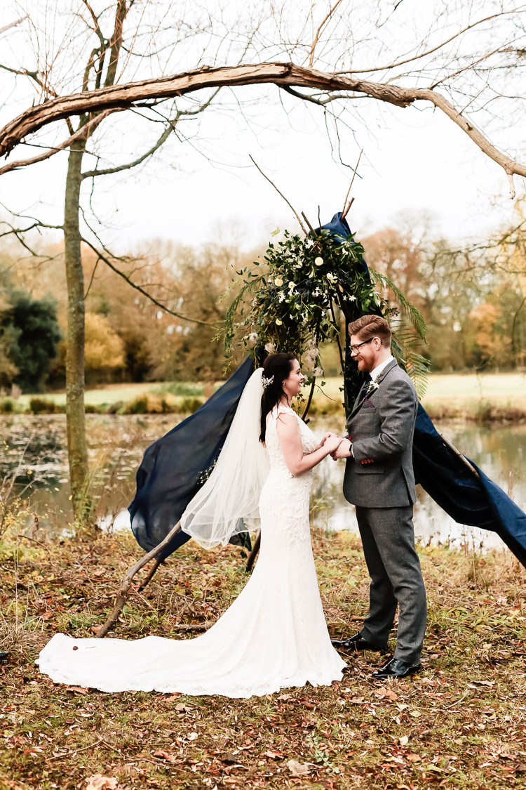 Tipi Backdrop Ceremony Drapes Flowers Magical Fairy Lit Blue Gold Winter Wedding Ideas https://sarahbrookesphotography.com/