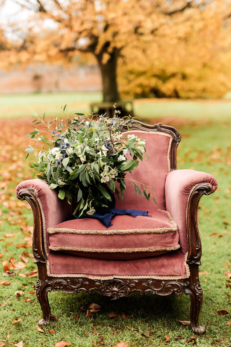 Bouquet Flowers Bride Bridal Greenery Thistle Ranunculus Velvet Chair Magical Fairy Lit Blue Gold Winter Wedding Ideas https://sarahbrookesphotography.com/