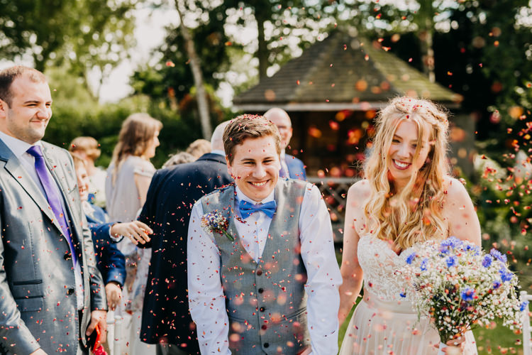 Bride Groom Outdoors Confetti Shot Colorful Petals Informal | Rustic Relaxed Cornflower Blue Barn Wedding http://www.peterhugophotography.com/