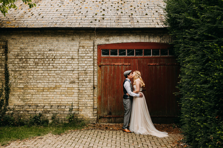 Bride Groom Outdoors Countryside Barn Romantic Kiss Photo | Rustic Relaxed Cornflower Blue Barn Wedding http://www.peterhugophotography.com/