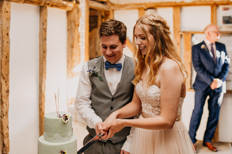 Bride Groom Cake Cutting Green Lace Flowers Simple Natural | Rustic Relaxed Cornflower Blue Barn Wedding http://www.peterhugophotography.com/