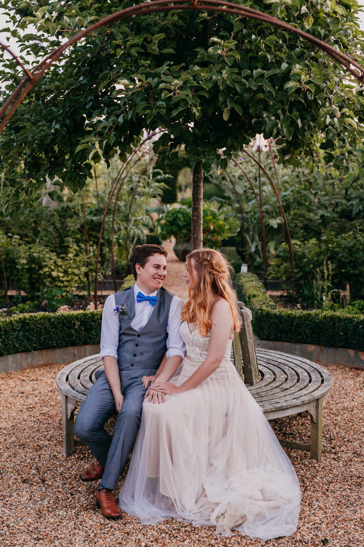Bride Groom Evening Garden Bench Smiling Informal Casual | Rustic Relaxed Cornflower Blue Barn Wedding http://www.peterhugophotography.com/
