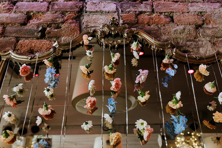 Urban Ceremony Backdrop Hanging Floral Curtain Pastel Wild Flowers | Glitter Dinosaurs City Wedding https://struvephotography.co.uk/