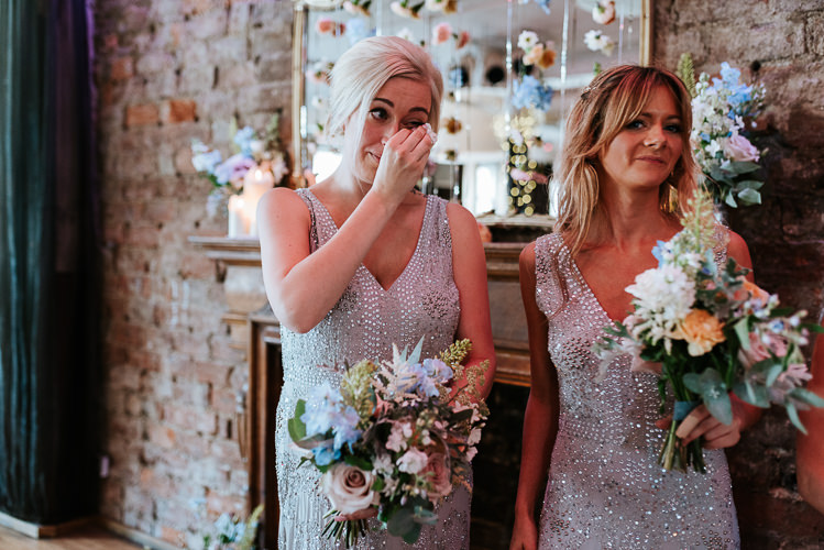 Silver Sequin Bridesmaid Dresses Colorful Pastel Bouquets Flower Curtain | Glitter Dinosaurs City Wedding https://struvephotography.co.uk/