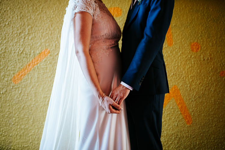 Bride Groom Quirky Fun Yellow Backdrop Caped Dress Navy Blue Suit | Glitter Dinosaurs City Wedding https://struvephotography.co.uk/