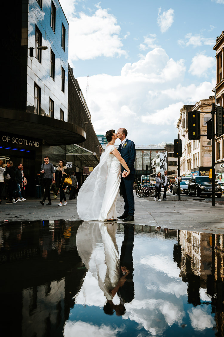 Bride Groom Caped Dress City Street Photography Puddle Reflection | Glitter Dinosaurs City Wedding https://struvephotography.co.uk/
