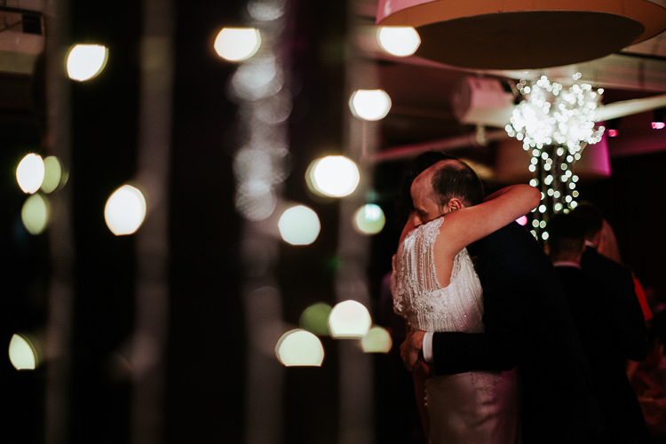 Bride Groom First Dance Embrace Lights Urban Venue | Glitter Dinosaurs City Wedding https://struvephotography.co.uk/