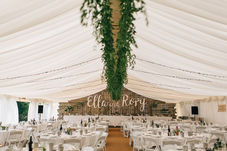 Marquee Greenery Fairy Lights Wooden Backdrop Name Decor Festival Bohemian Glamping Wedding https://theshannons.photography/