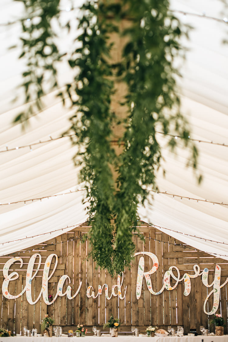 Marquee Greenery Fairy Lights Wooden Backdrop Name Decor Festival Bohemian Glamping Wedding https://theshannons.photography/