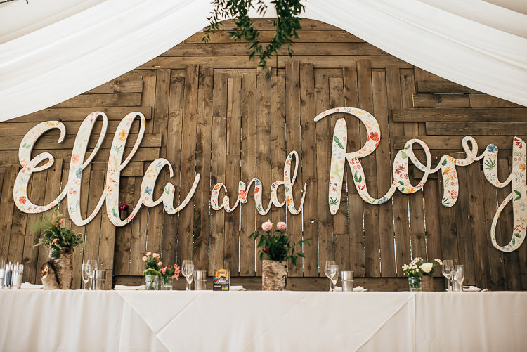 Marquee Greenery Fairy Lights Wooden Backdrop Name Decor Festival Bohemian Glamping Wedding https://theshannons.photography/