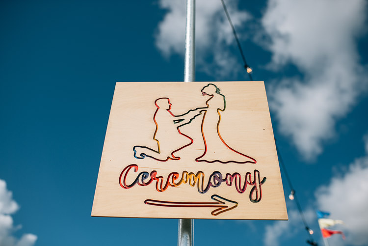 Engraved Wooden Sign Rainbow Signage Directions Post Festival Bohemian Glamping Wedding https://theshannons.photography/