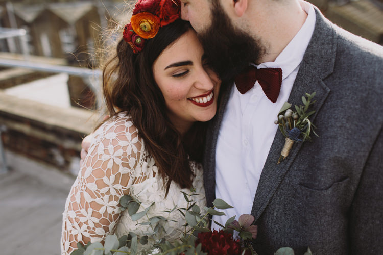 Bride Bridal Dress Gown Lace Long Sleeve Sweetheart Bouquet Red Burgundy Rose Greenery Eucalyptus Flower Crown Tweed Groom Bow Tie Grey Alternative London Warehouse Wedding https://www.lukehayden.co.uk/