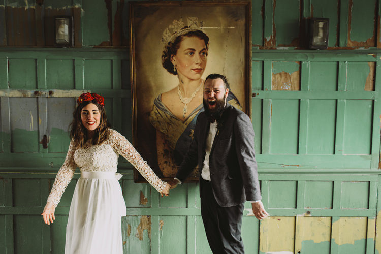 Bride Bridal Dress Gown Lace Long Sleeve Sweetheart Bouquet Red Burgundy Rose Greenery Eucalyptus Flower Crown Grey Tweed Groom Bow Tie Mismatched One Friendly Place Alternative London Warehouse Wedding https://www.lukehayden.co.uk/