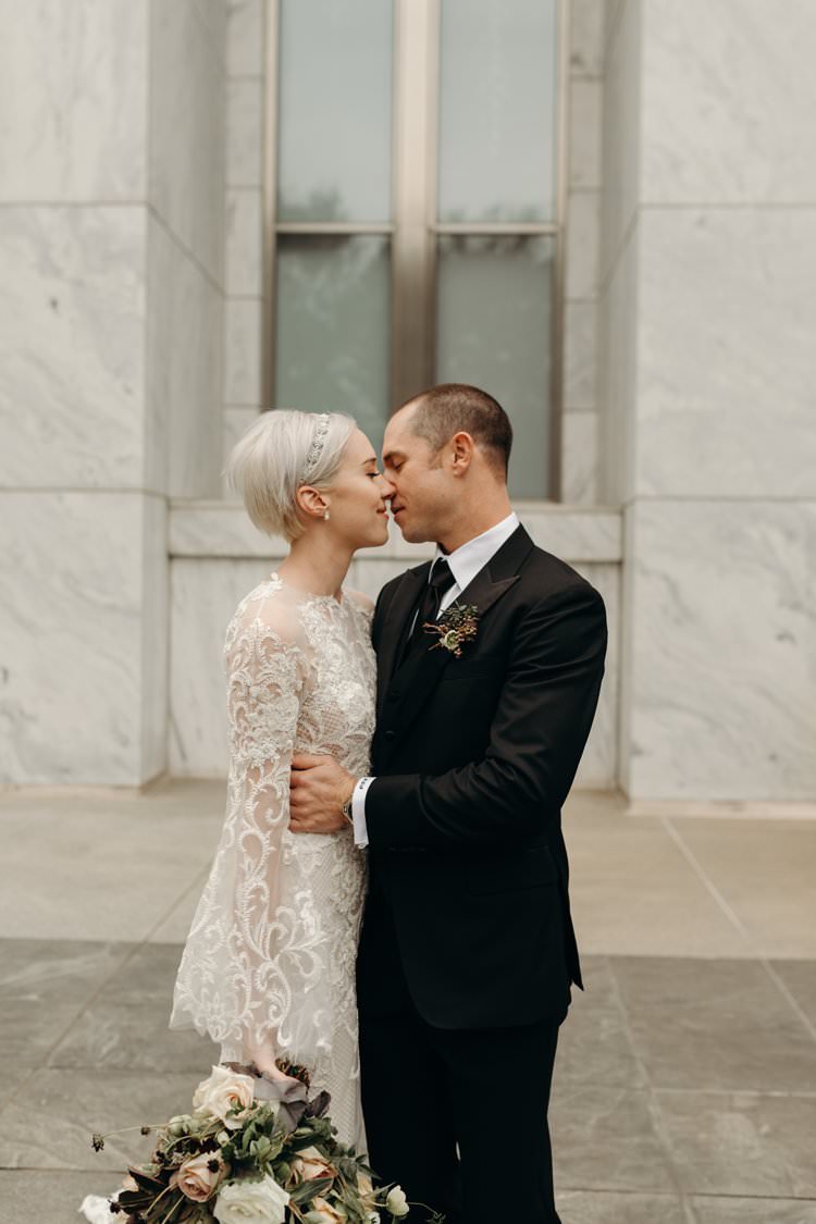 Modern Stylish Chic Bridalwear Wedding Dress Long Bell Sleeves Intricate Illusion Lace Short Hair Groom Kiss | Urban Industrial Luxe Wedding http://hellencophotos.com/