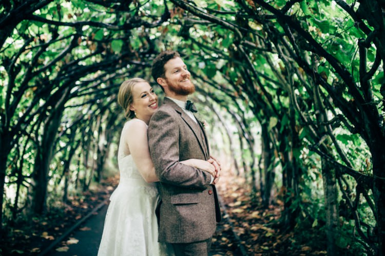 Bride Bridal Dress Gown Tea Length Sweetheart Neckline Lace Tweed Three Piece Waistcoat Suit Bow Tie Old Fashioned Fete Cricket Pavilion Wedding https://www.naomijanephotography.com/