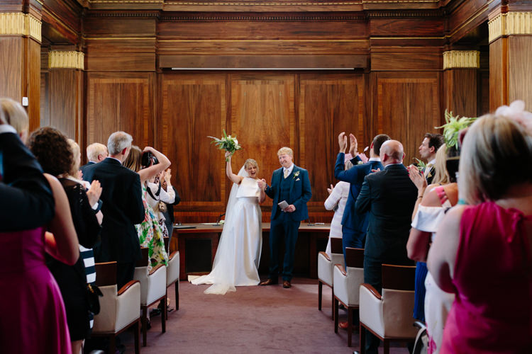 London Stoke Newington Town Hall Aisle Civil Ceremony Bride Groom Celebrate Happy | Modern Tropical Gold Urban Wedding https://www.christinewehrmeier.com/