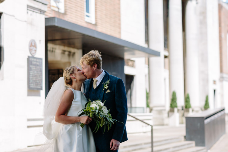 Sunny North London Stoke Newington Town Hall Bride Groom Outdoor Photographs Kiss | Modern Tropical Gold Urban Wedding https://www.christinewehrmeier.com/