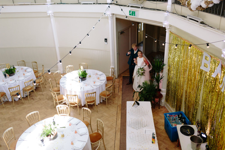 London Shoreditch The Tab Centre Wedding White Gold Green Tropical Festoon Lights Paper Pompoms | Modern Tropical Gold Urban Wedding https://www.christinewehrmeier.com/