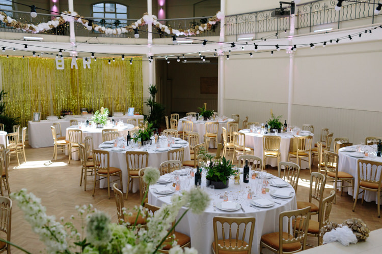 London Shoreditch The Tab Centre Wedding White Gold Green Tropical Festoon Lights Paper Pompoms | Modern Tropical Gold Urban Wedding https://www.christinewehrmeier.com/