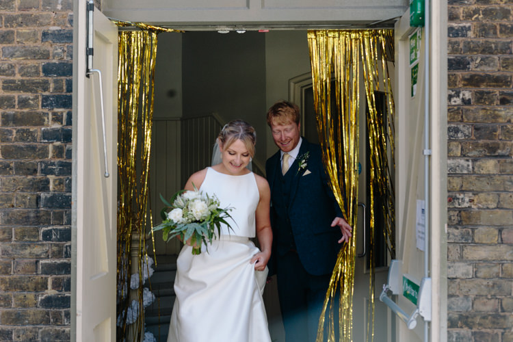 London City Urban Gold Glitter Curtain Bride Groom Foliage Green Bouquet Simple Jesus Peiro Dress | Modern Tropical Gold Urban Wedding https://www.christinewehrmeier.com/