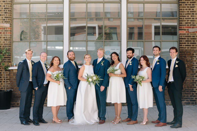 Bride Jesus Peiro Dress White Bridesmaids ASOS Simple Foliage Greenery Gold Bouquet Groom Groomsmen Navy Suit | Modern Tropical Gold Urban Wedding https://www.christinewehrmeier.com/