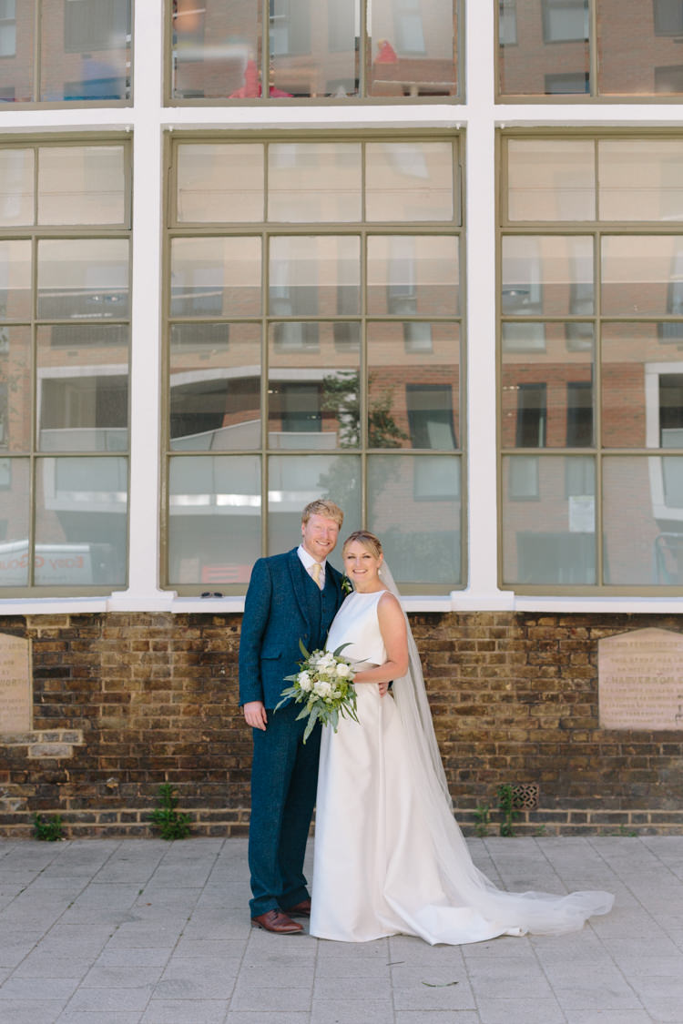 London City Bride Groom Buildings Street Foliage Greenery White Bouquet Jesus Peiro Dress Navy Suit | Modern Tropical Gold Urban Wedding https://www.christinewehrmeier.com/
