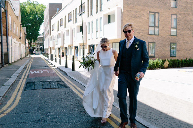 London City Bride Groom Buildings Street Foliage Greenery White Bouquet Jesus Peiro Dress Navy Suit | Modern Tropical Gold Urban Wedding https://www.christinewehrmeier.com/