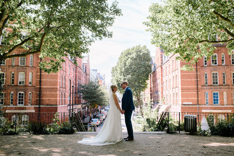 London City Bride Groom Buildings Street Park Jesus Peiro Dress Navy Suit | Modern Tropical Gold Urban Wedding https://www.christinewehrmeier.com/