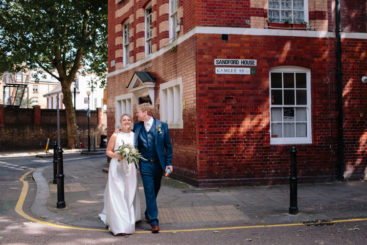 London City Bride Groom Buildings Street Foliage Greenery White Bouquet Jesus Peiro Dress Navy Suit | Modern Tropical Gold Urban Wedding https://www.christinewehrmeier.com/