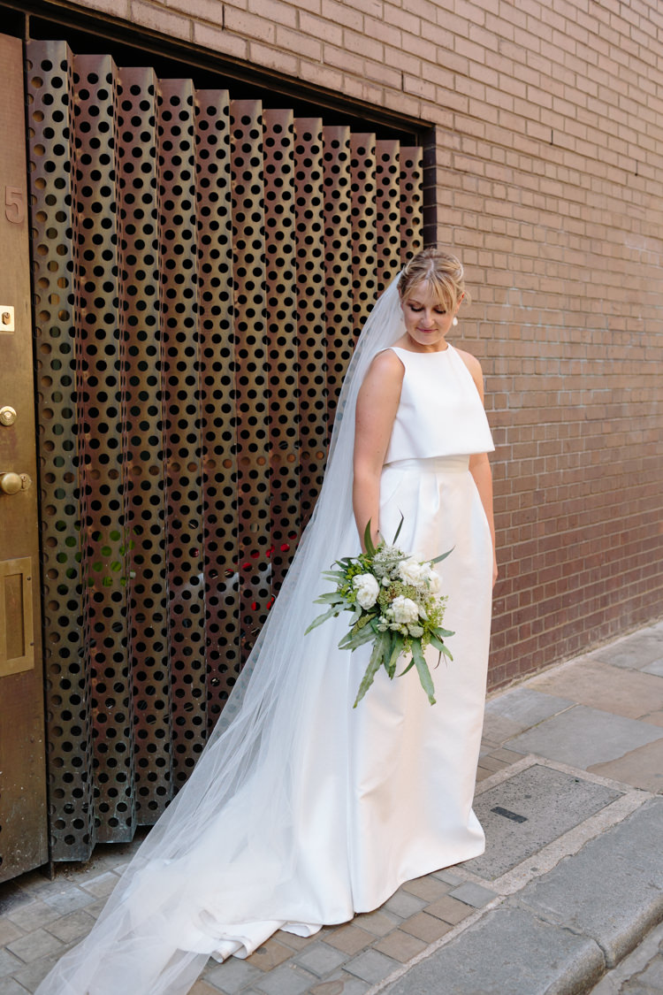 London Bride Brick Wall Street Foliage Greenery White Bouquet Jesus Peiro Dress | Modern Tropical Gold Urban Wedding https://www.christinewehrmeier.com/