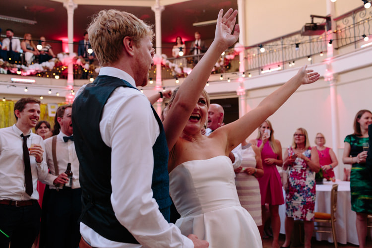 London Shoreditch The Tab Centre Wedding White Gold Green Tropical Festoon Lights Paper Pompoms First Dance | Modern Tropical Gold Urban Wedding https://www.christinewehrmeier.com/
