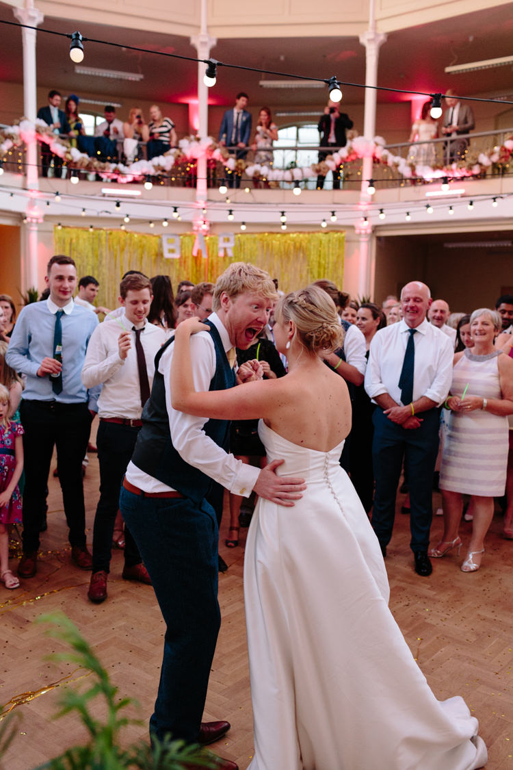 London Shoreditch The Tab Centre Wedding White Gold Green Tropical Festoon Lights Paper Pompoms First Dance | Modern Tropical Gold Urban Wedding https://www.christinewehrmeier.com/