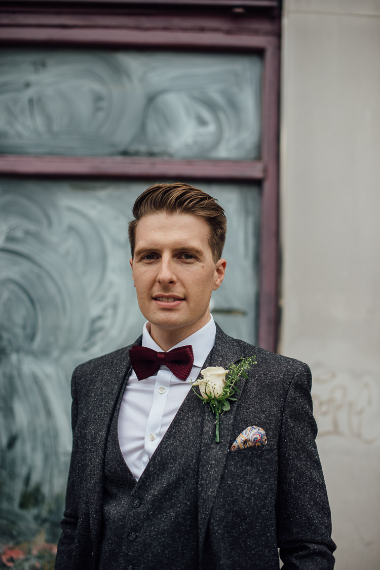 Groom Three Piece Suit Waistcoat Grey Tweed Burgundy Bow Tie Pocket Square Chic Relaxed London Pub Wedding https://theshannons.photography/