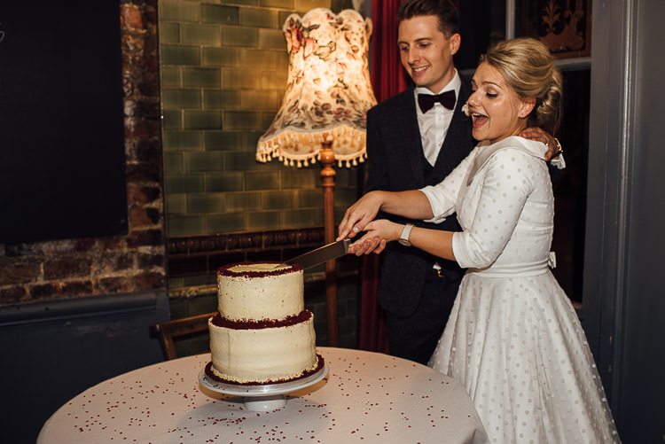 Bride Bridal Candy Anthony Polka Dot Peter Pan Collar Tea Length Groom Three Piece Suit Waistcoat Grey Tweed Burgundy Bow Tie Pocket Square Cake Cutting Red Velvet ButtercreamChic Relaxed London Pub Wedding https://theshannons.photography/