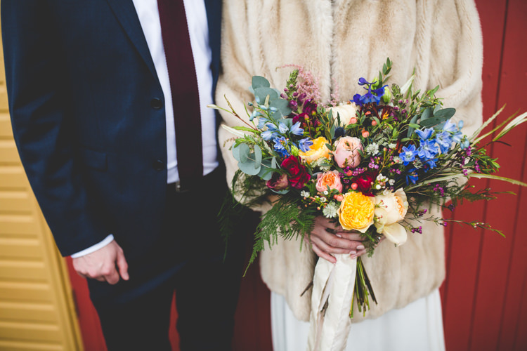 Groom Navy Suit Bride Bridal Floor Length T Shirt Neckline Short Sleeves Multicolour Wild Flower Bouquet Fur Jacket Colourful Fun Cosy Rainy Sea Wedding http://www.livvy-hukins.co.uk/