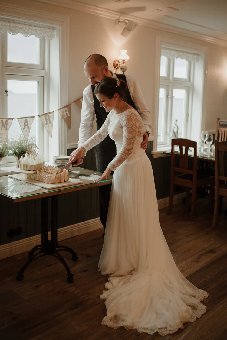 Bride Groom Destination Elopement Neutral Elegant Simple Minimalist Decor Restaurant Reception Cake Cutting | Intimate Adventurous Emotional Iceland Wedding http://www.thecurries.co/