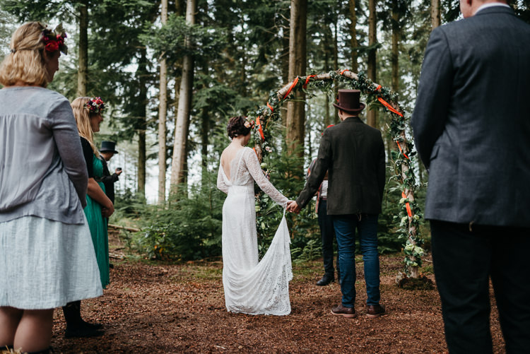 Bride Bridal Vintage Lace Dress Long Sleeved Flower Crown Bouquet White Stuff Groom No Tie Waistcoat Three Piece Suit Top Hat Tweed Foliage Flower Arch Folky Woodland Adventure Wedding https://elainewilliamsphoto.com/
