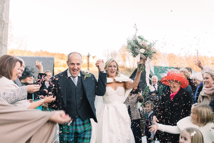 Bride Bridal Sweetheart Neckline Hair Piece Lace A Line Faux Fur Stole Cape Tartan Trousers Groom Three Piece Waistcoat Tweed Jacket Confetti Shot Enchanted Magical Snowy Wedding https://www.thegibsonsphotography.co.uk/