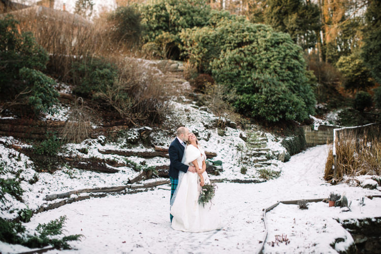 Bride Bridal Sweetheart Neckline Hair Piece Lace A Line Faux Fur Stole Cape Tartan Trousers Groom Three Piece Waistcoat Tweed Jacket Enchanted Magical Snowy Wedding https://www.thegibsonsphotography.co.uk/