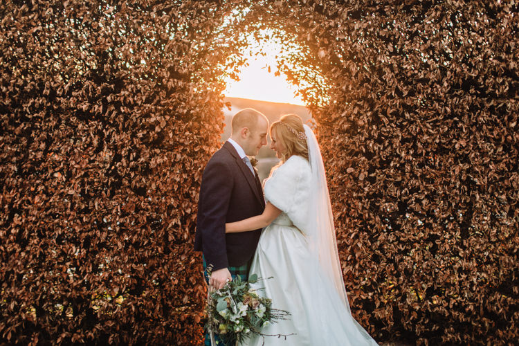 Bride Bridal Sweetheart Neckline Hair Piece Lace A Line Faux Fur Stole Cape Tartan Trousers Groom Three Piece Waistcoat Tweed Jacket Enchanted Magical Snowy Wedding https://www.thegibsonsphotography.co.uk/