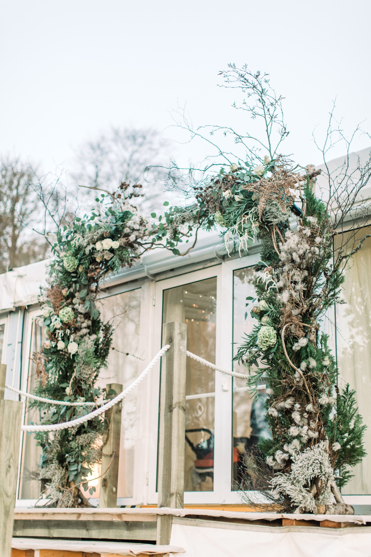 Floral Foliage Arch Twigs Marquee Enchanted Magical Snowy Wedding https://www.thegibsonsphotography.co.uk/