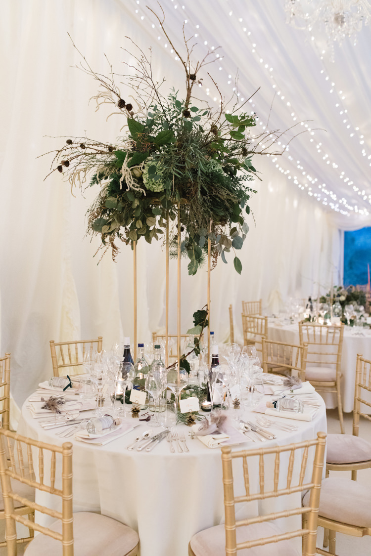 Table Setting Pedestal Arrangement Foliage Twigs Tall Enchanted Magical Snowy Wedding https://www.thegibsonsphotography.co.uk/
