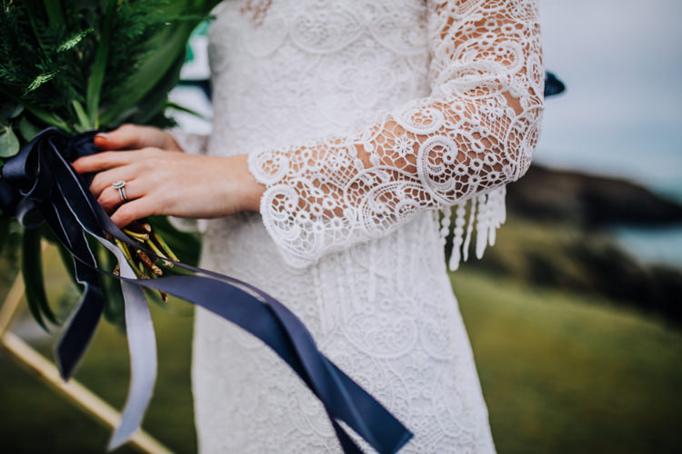 Dress Lace Sleeves Bride Bridal Hair Long Fringe Tassel Ocean Clifftop Elopement Wedding Ideas North Wales https://www.claracooperphotography.com/