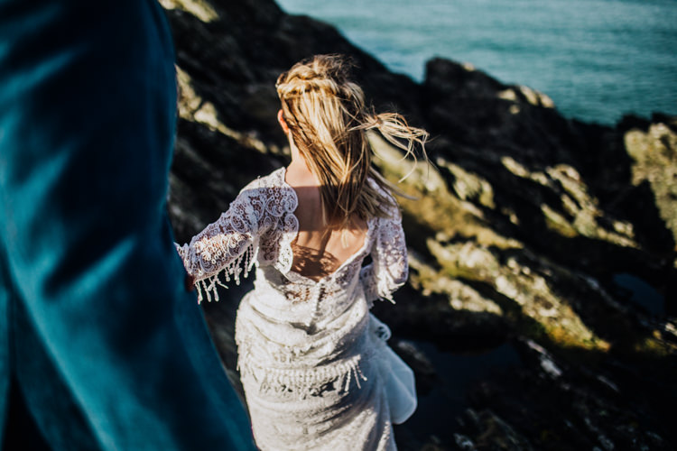 Dress Lace Sleeves Bride Bridal Hair Long Fringe Tassel Ocean Clifftop Elopement Wedding Ideas North Wales https://www.claracooperphotography.com/