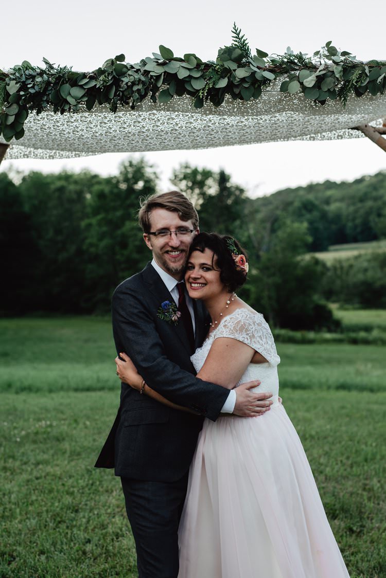 Outdoor Field Forest Wild Nature Marquee Tipi Floral Arch Bride Groom Embrace| Breathtaking Secluded Back Garden Open Sided Tent Wedding Vermont https://kickasscouples.com/