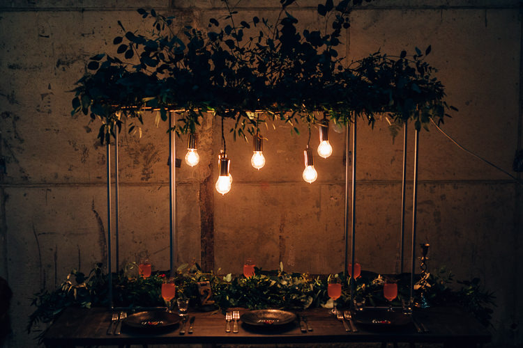 Table Tablescape Flowers Black Plates Calligraphy Swag Garland Suspended Edgy Raw Industrial Barn Wedding Ideas Greenery Festoon Lights http://www.two-d.co.uk/