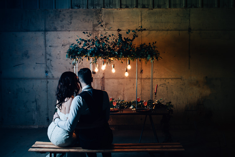 Table Tablescape Flowers Black Plates Calligraphy Swag Garland Suspended Edgy Raw Industrial Barn Wedding Ideas Greenery Festoon Lights http://www.two-d.co.uk/
