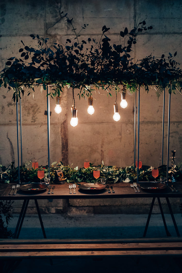 Table Tablescape Flowers Black Plates Calligraphy Swag Garland Suspended Edgy Raw Industrial Barn Wedding Ideas Greenery Festoon Lights http://www.two-d.co.uk/