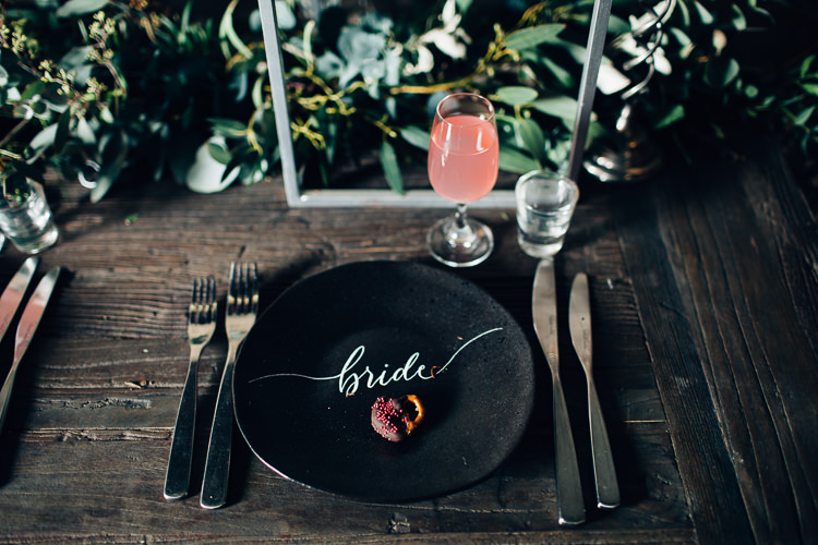 Table Tablescape Flowers Black Plates Calligraphy Swag Garland Edgy Raw Industrial Barn Wedding Ideas Greenery Festoon Lights http://www.two-d.co.uk/
